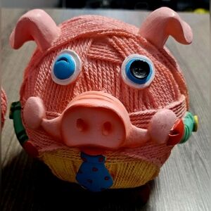 Two whimsical yarn ball winking pig figurines